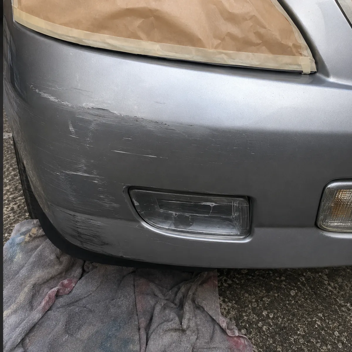 Headlight restoration: bumper scuff before Mark's repair